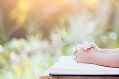 a close up of a person's hand resting on an open book