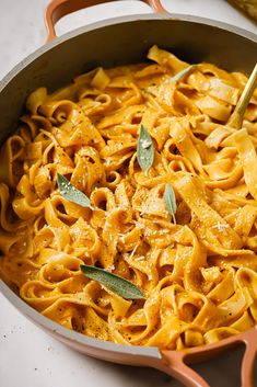 a skillet filled with pasta and sage