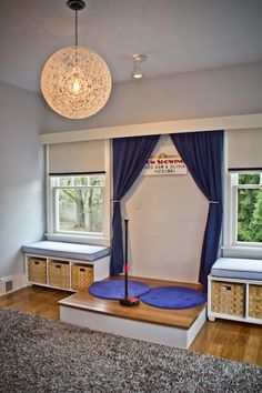 a living room filled with furniture and windows