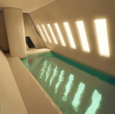 an indoor swimming pool with sun shining through the windows and reflecting light on the floor