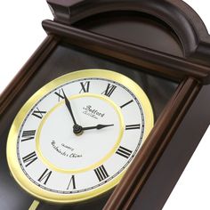 a clock with roman numerals is shown in brown and gold trim on a white background