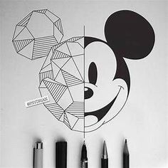 a mickey mouse wall decal with some pens around it and another drawing on the wall