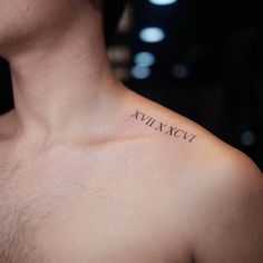 a man's chest with roman numerals tattooed on his left side shoulder