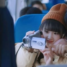 a man and woman sitting next to each other with a camera