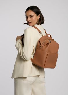 Stevie Midi is gender-neutral, edgy, and has the space to hold just the essentials. From a hike to the store, from work to the park, her eight internal pockets and easy-to-clean microfiber vegan leather make her the perfect bag to take just about anywhere. This ‘just right size’ is ideal for the mama who’s ready to downsize, and who likes nice things yet doesn’t want to fear the rough & tumble. Stevie’s all about options – her backpack converts to a shoulder strap, and her intuitive internal organization encourages minimalist-yet-prepared packing. Wear her as you please, pack her with ease. Ideal for newborn or essentialist packing. Common Uses: Diaper Bag, Work Bag, Travel Bag, Everyday Backpack Versatile On-the-go Diaper Backpack, Backpack Diaper Bag With Zipper Closure For On-the-go, Trendy Travel Backpack With Zipper Pocket, On-the-go Diaper Backpack With Zipper, Versatile Diaper Bag Backpack With Removable Pouch, Modern Backpack With Large Capacity, Modern Large Capacity Softback Backpack, Modern Diaper Bag Backpack With Zipper Closure, Everyday Softback Backpack With Large Capacity