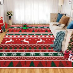 a living room decorated for christmas with red and green rugs on the hardwood floor