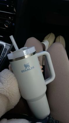 a person holding a cup in their lap