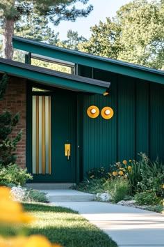 a green house with yellow lights on the front door