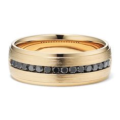 a wedding band with black diamonds on it and gold inlays, set against a white background