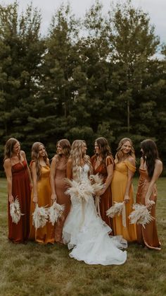 a group of women standing next to each other on top of a lush green field