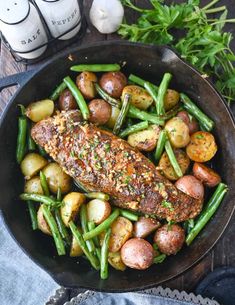 a pan filled with meat, potatoes and green beans