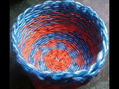 an orange and blue basket sitting on top of a table