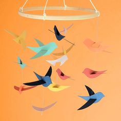 there is a mobile made out of paper birds