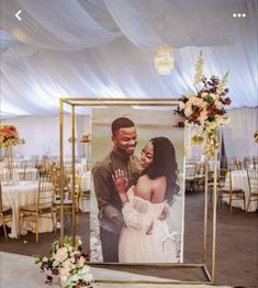 an image of a couple on their wedding day in front of a table with flowers