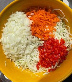 a yellow bowl filled with different types of chopped onions and carrots on top of each other