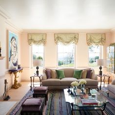 a living room filled with furniture and windows