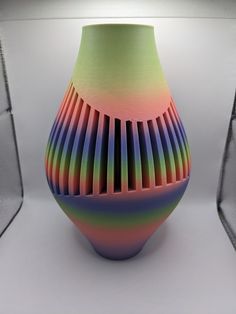 a multicolored vase sitting on top of a white table