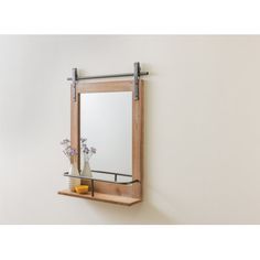 a wooden shelf with a mirror and vase on it