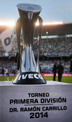 the trophy is displayed in front of an empty stadium