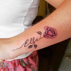 a woman's arm with a rose tattoo and the word eva written in cursive writing