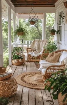 a porch with wicker furniture and potted plants