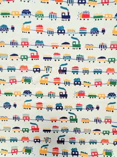 a white background with colorful trains and cars on the train tracks in blue, green, yellow, red, orange, and pink