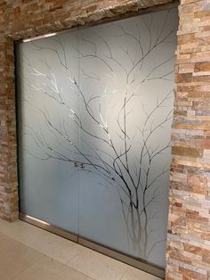 a glass door with a tree painted on it