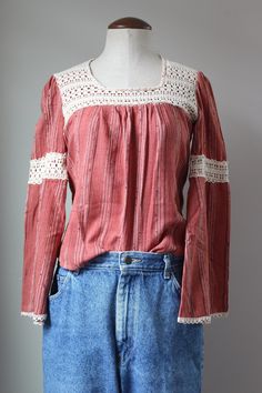 "Cutest vintage hippie blouse from the 70s! Intricate, hand crocheted lace - this would have taken a LONG time to make by hand. Slight bell sleeves and billowy empire waist. Cozy cotton blend fabric. 50% cotton, 50% polyester. Dark pink/red color. Label is faded, no brand or sizing legible. Estimated size S. Please see measurements for accurate fit. Measurements (taken laid flat, doubled where necessary): Length: 21\" Shoulders: 14\" Chest: 34\" Sleeve length: 22\" Condition: Excellent vintage c Hippie Cotton Crochet Tops, Bohemian Fitted Tops With Crochet Trim, Fitted Bohemian Tops With Crochet Trim, Fitted Cotton Crochet Top In Hippie Style, Bohemian Cotton Crochet Blouse, Bohemian Crochet Cotton Blouse, Vintage Cotton Tops With Boho Collar, Bohemian Cotton Blouse With Lace Patchwork, Bohemian Cotton Tops With Crochet Lace