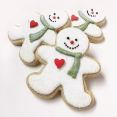 decorated cookies with frosting and hearts are arranged in the shape of a snowman