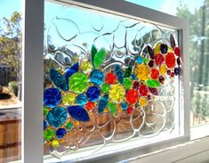 a stained glass window with colorful flowers on it