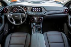 the interior of a car with dashboard and steering wheel controls, including an automatic clock