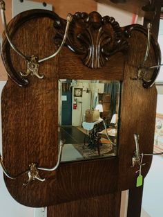 a mirror that is on the side of a wooden wall hanging from a hook in a room