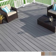 an outdoor deck with chairs and pillows on it, next to a potted plant