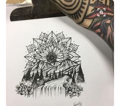 a drawing of a sunflower on top of a piece of paper with mountains in the background