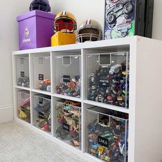 a shelf filled with lots of toys and bins on top of it's sides