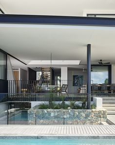 an outdoor swimming pool and patio area in a modern home