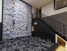 an indoor climbing wall in the middle of a room