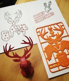 two christmas cards, one with reindeer heads and the other with deer antlers on them