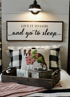 a bed room with a wooden tray on top of it and a sign above the bed