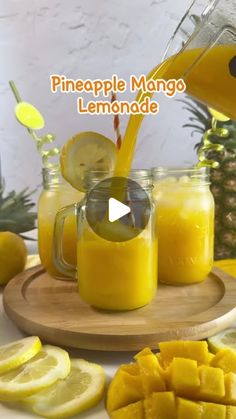 pineapple mango lemonade is being poured into mason jars