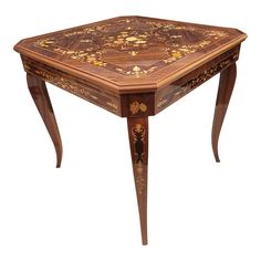 a wooden table with an intricate design on it's top and bottom corner, inlayed with flowers