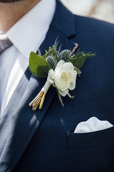 a man in a suit with a boutonniere on his lapel