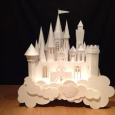 a castle made out of paper sitting on top of a wooden table