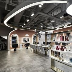 the interior of a hair salon with lots of chairs and shelves filled with products on display