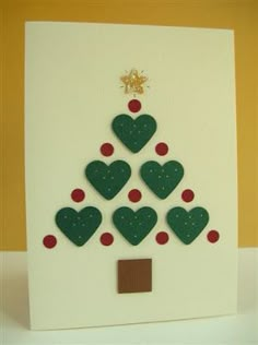 a christmas tree made out of felt on top of a white card with red and green dots