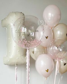 some balloons that are in the shape of an i love you balloon with pink and gold confetti