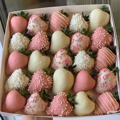 a box filled with pink and white chocolate covered strawberries