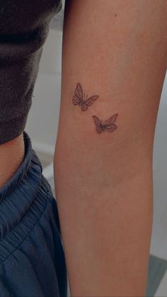 two butterflies tattoo on the left arm