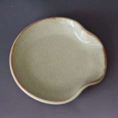 a white and brown bowl sitting on top of a table