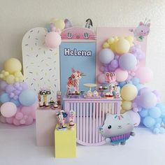 there is a baby shower with balloons and decorations on the wall, along with other items